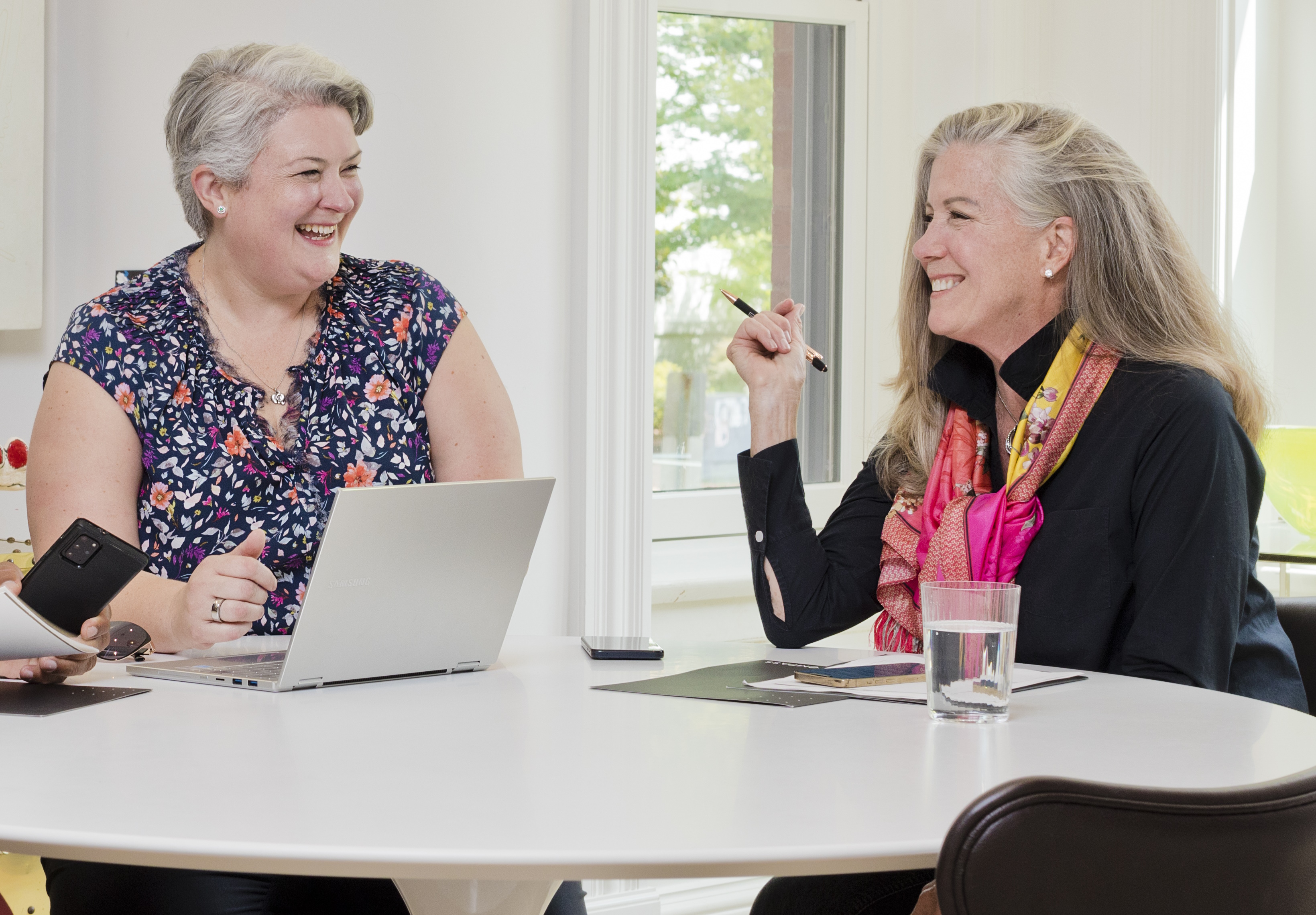 Avery Boyce and Deirdre Jo Fricke at the office table